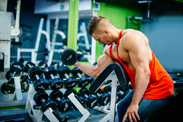 istock Body builder exercising biceps in gym 639492688