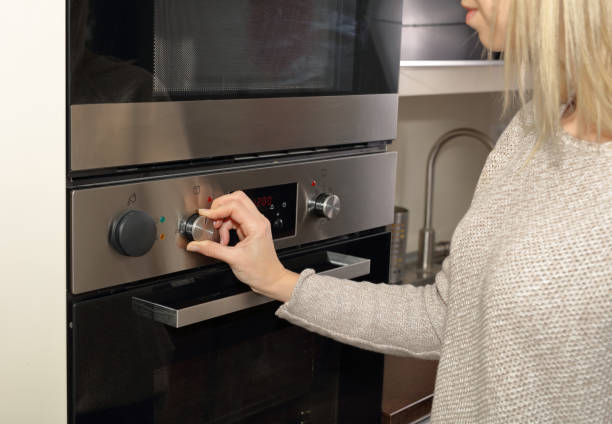 istock Young Woman Preparing diner in Oven At Home Kitchen 639493600