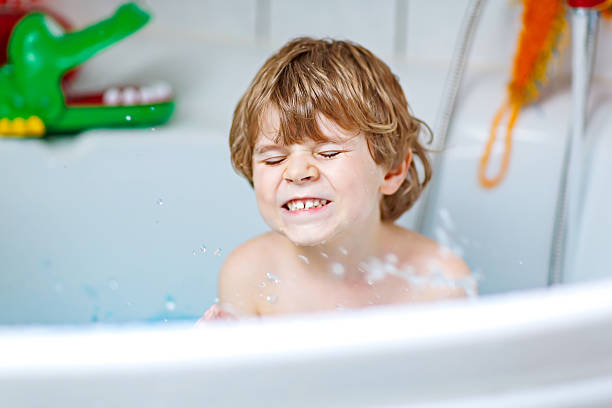 istock cute little kid boy playing with soap in bathtub 639493682
