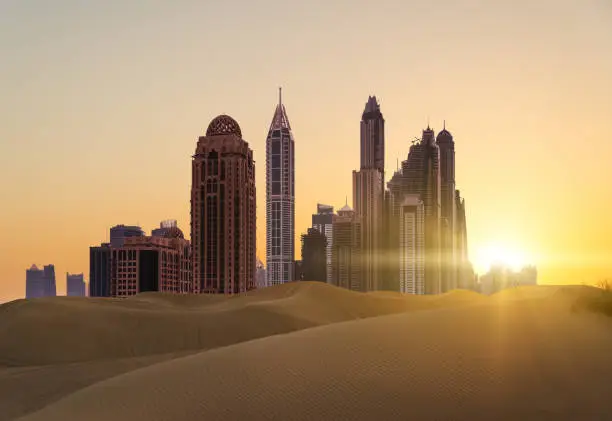 Sunset over modern city, view from desert