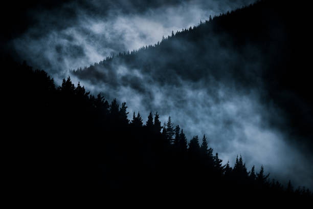 scary foggy mountain at nigh stock photo
