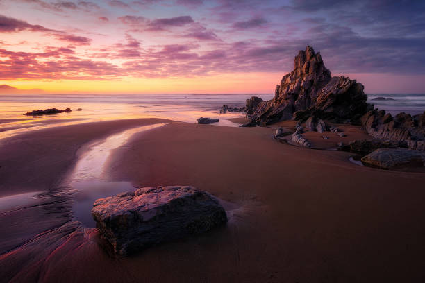 istock rock in Sopelana beach at sunset 639496784