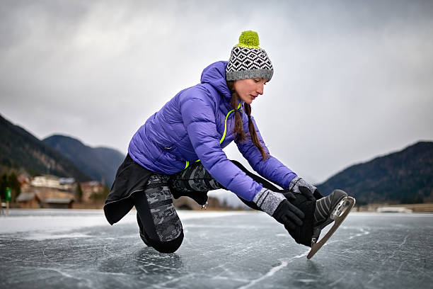 istock Woman fixing ice skate shoe 639496794
