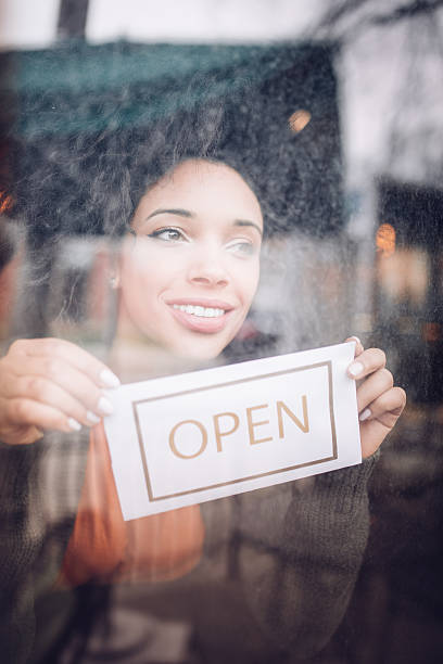 istock Women hold a sign open 639498374