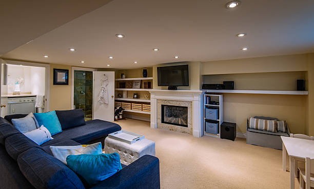 Modern Basement interior Interior of modern renovated lover floor basement common room with addition of bathroom and laundry room, in private city  residence. common room stock pictures, royalty-free photos & images