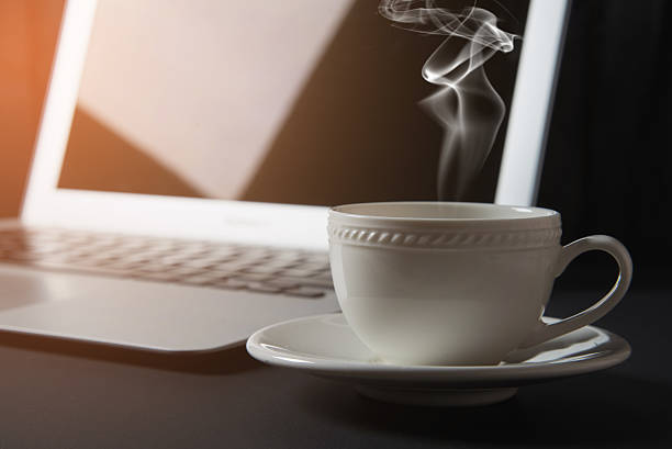 istock cup of coffee and laptop on the table 639502318