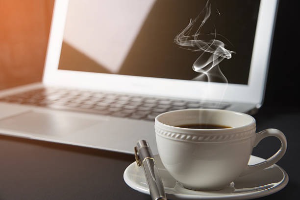 istock cup of coffee and laptop on the table 639502578