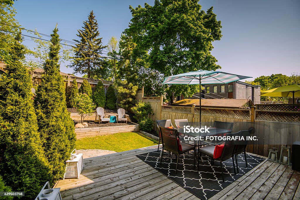 City home exterior Exterior of typical North American city residence. Backyard with deck and barbeque. Yard - Grounds Stock Photo