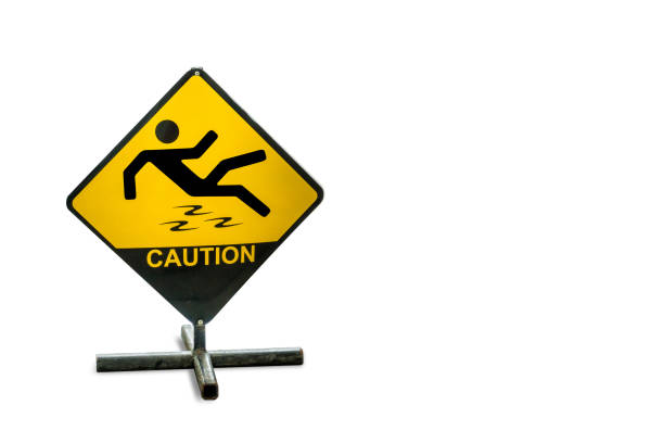 Trip hazard sign as a hose pipe crosses a pathway