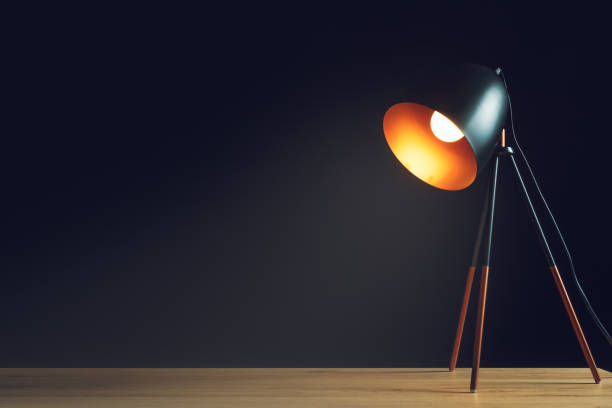 istock Desk lamp on empty wooden office table 639505916