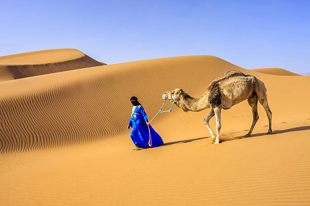 Young Tuareg with camel on Western Sahara Desert in Africa Tuareg with camels on the western part of The Sahara Desert in Morocco. The Sahara Desert is the world's largest hot desert. bedouin photos stock pictures, royalty-free photos & images