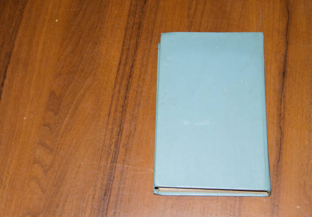 istock Old book on wooden table 639507984