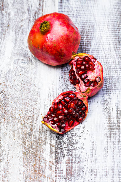 istock cut pomegranate isolated on a wooden background 639509298