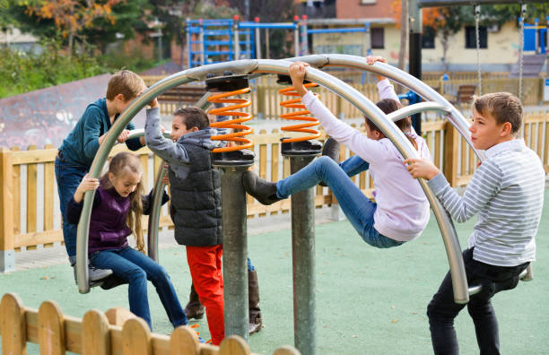 istock Boy in elementary school age riding toy on children's playground 639509558