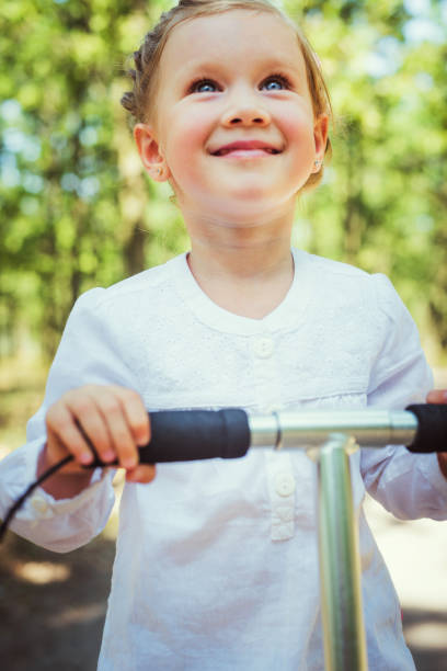 istock girl riding scooter 639510260