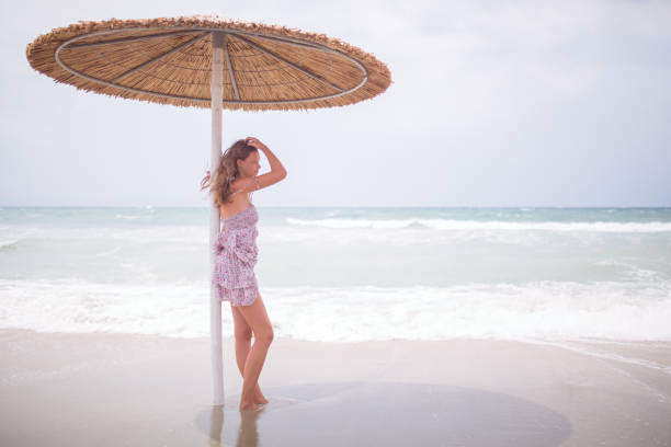 istock Beautiful young woman on the beach 639510346