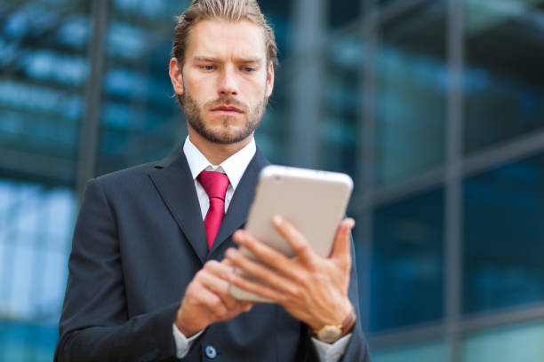 istock Portrait of a businessman using his tablet 639511324