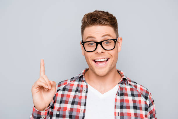 istock Young handsome happy man in glasses having an idea 639511778