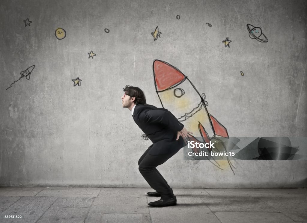 Man is carrying a rocket Businessman is carrying a rocket on his shoulder Moon Stock Photo