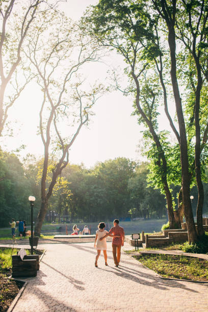 istock couple relax in park at sunset 639511880