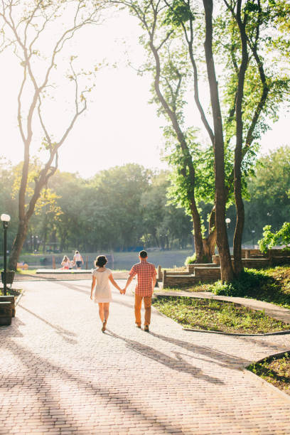 istock couple relax in park at sunset 639513058