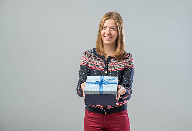 istock Young happy woman with a gift 639513294