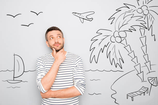 istock man dreaming about vacation and looking at drawing on wall 639513772