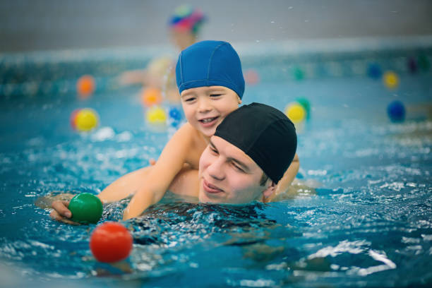 istock Father with son in the pool 639513834