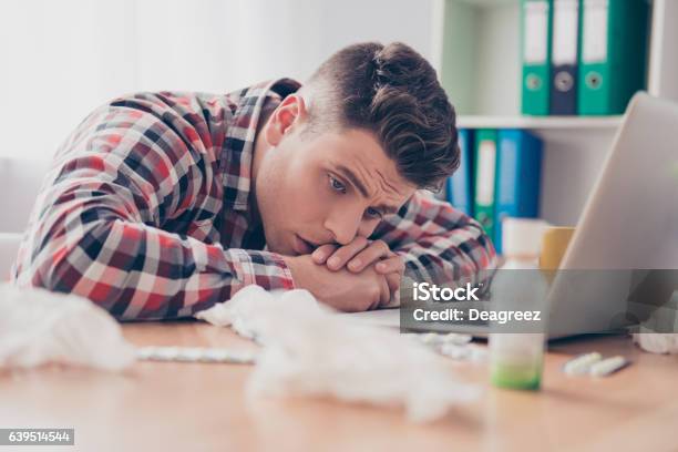 Unhealthy Manager With High Temperature Lying On Working Table Stock Photo - Download Image Now