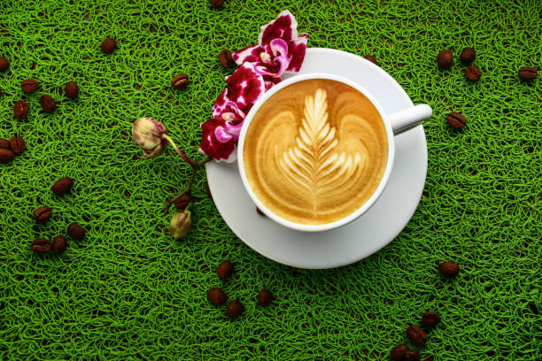 istock cup of cappuccino on a green table 639515484