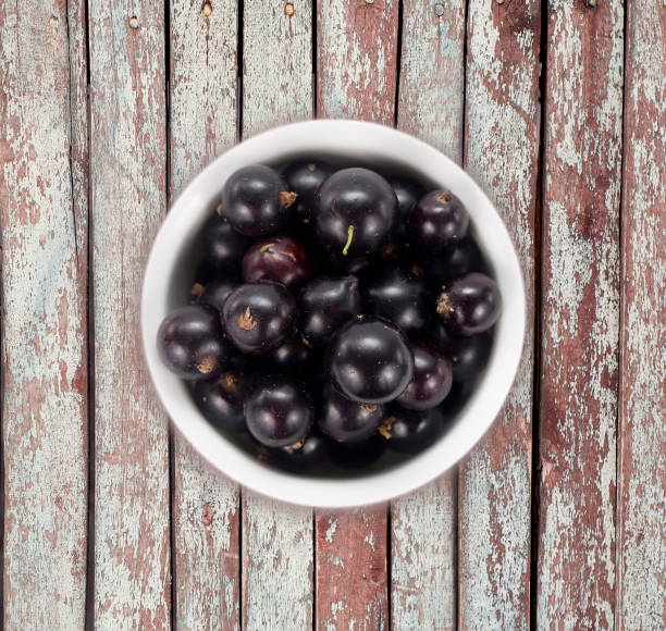 istock Black currants on wooden table with copy space 639515860