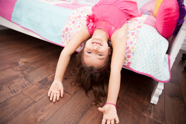 Playful little girl goofing around in her bedroom Playful little girl goofing around in her bedroom child 10 11 years 8 9 years cheerful stock pictures, royalty-free photos & images