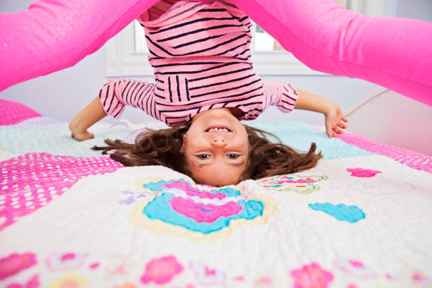 Playful little girl goofing around in her bedroom Playful little girl goofing around in her bedroom child 10 11 years 8 9 years cheerful stock pictures, royalty-free photos & images