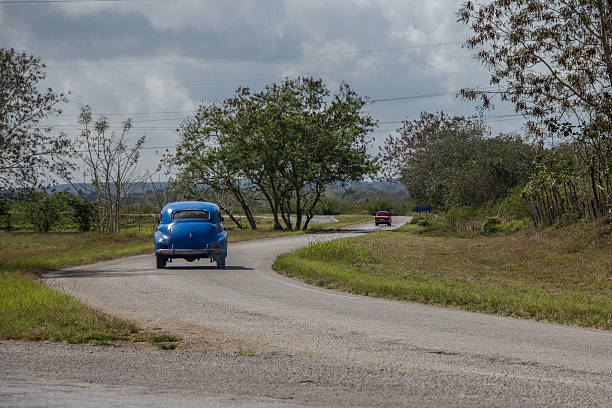 istock Classic blue cuban car driving on a highway. 639521074