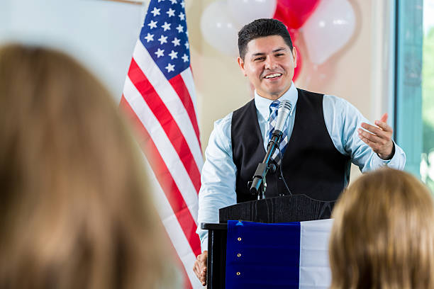 istock Confident Hispanic politician addresses supporters during rally 639522828
