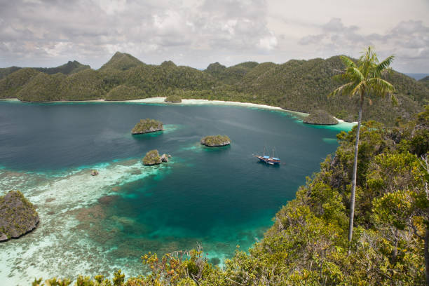 istock Tropical Lagoon, Islands, and Schooner in Raja Ampat 639522986