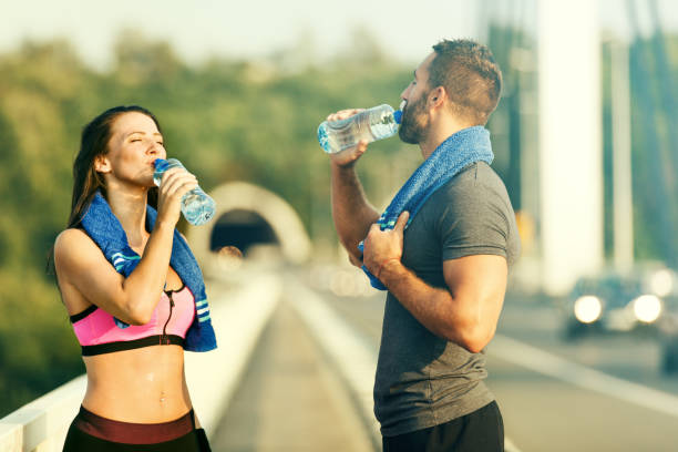 istock Happy Couple Exercising Outdoors. Drinking Water. 639523228