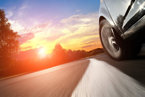 The car moves on fast speed at night. Blured road with lights with car on high speed