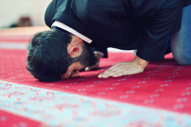 istock Younger Muslim man praying in colorful mosque 639526452