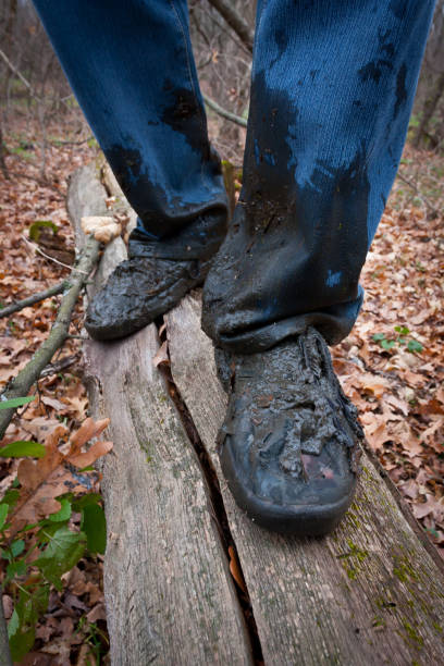 istock boots men in the dirt on a log in forest 639526502