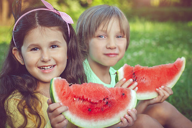 istock Little boy and girl with watermelon 639526706