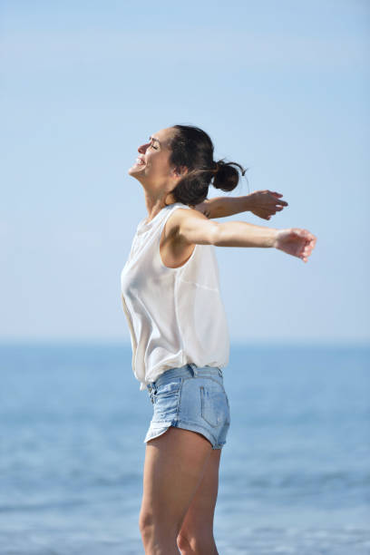 istock Young female enjoying sunny day on tropical beach 639526904