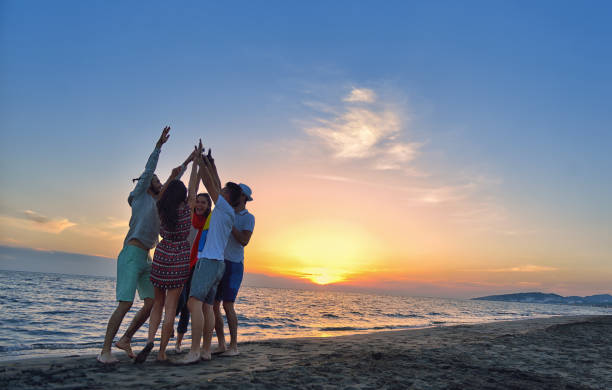 istock group of young people dancing at the beach 639532980