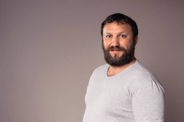 istock Happy handsome bearded man in gray t-shirt looking at camera. 639533358