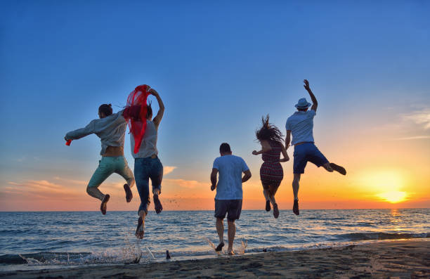 istock group of young people dancing at the beach 639533976