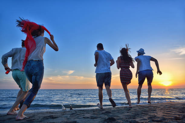 istock group of young people dancing at the beach 639534098