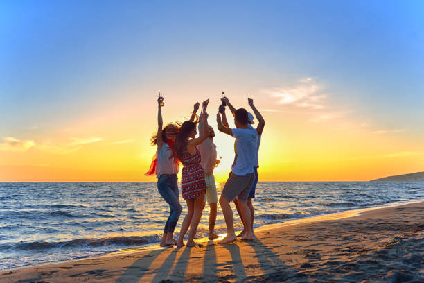 istock group of young people dancing at the beach 639534166