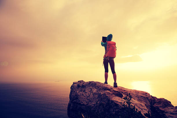 istock hiker use digital tablet taking photo on seaside mountain peak 639534268