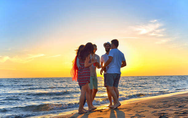 istock group of young people dancing at the beach 639534424