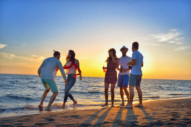 istock group of young people dancing at the beach 639534566